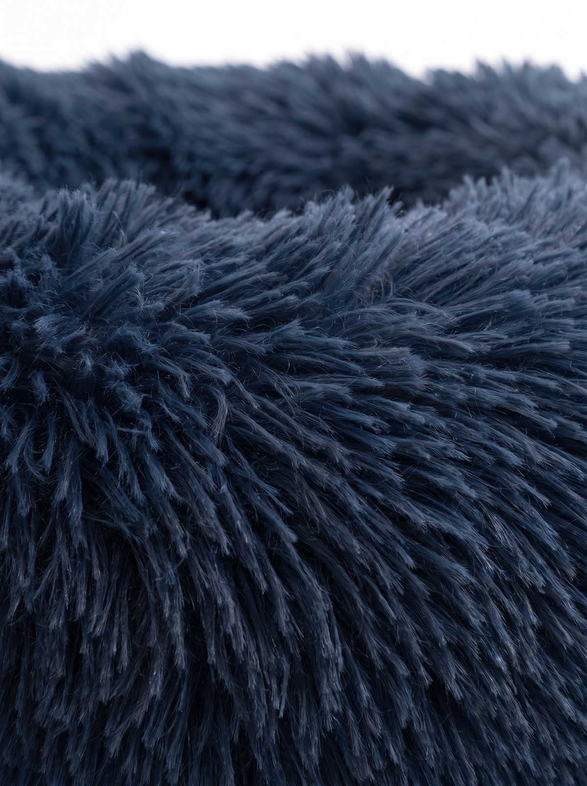 Close up of the fluffy faux fur surface of the Leila donut dog bed
